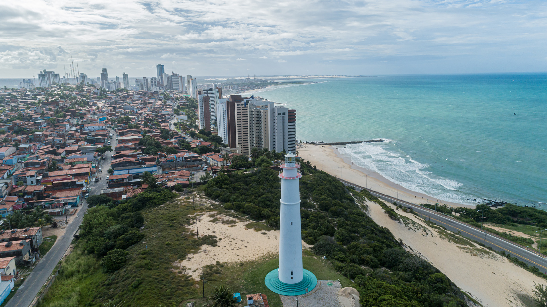 Aerial view of lighthouse at top of leafy dune in Natal